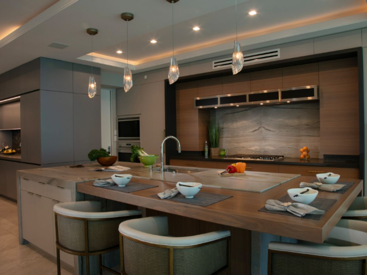 Luxury custom kitchen cabinets Siesta Key — contemporary slab-door cabinetry in La Paloma Gray and Rift Sawn Walnut with granite and walnut island countertops by EuroTech Cabinetry