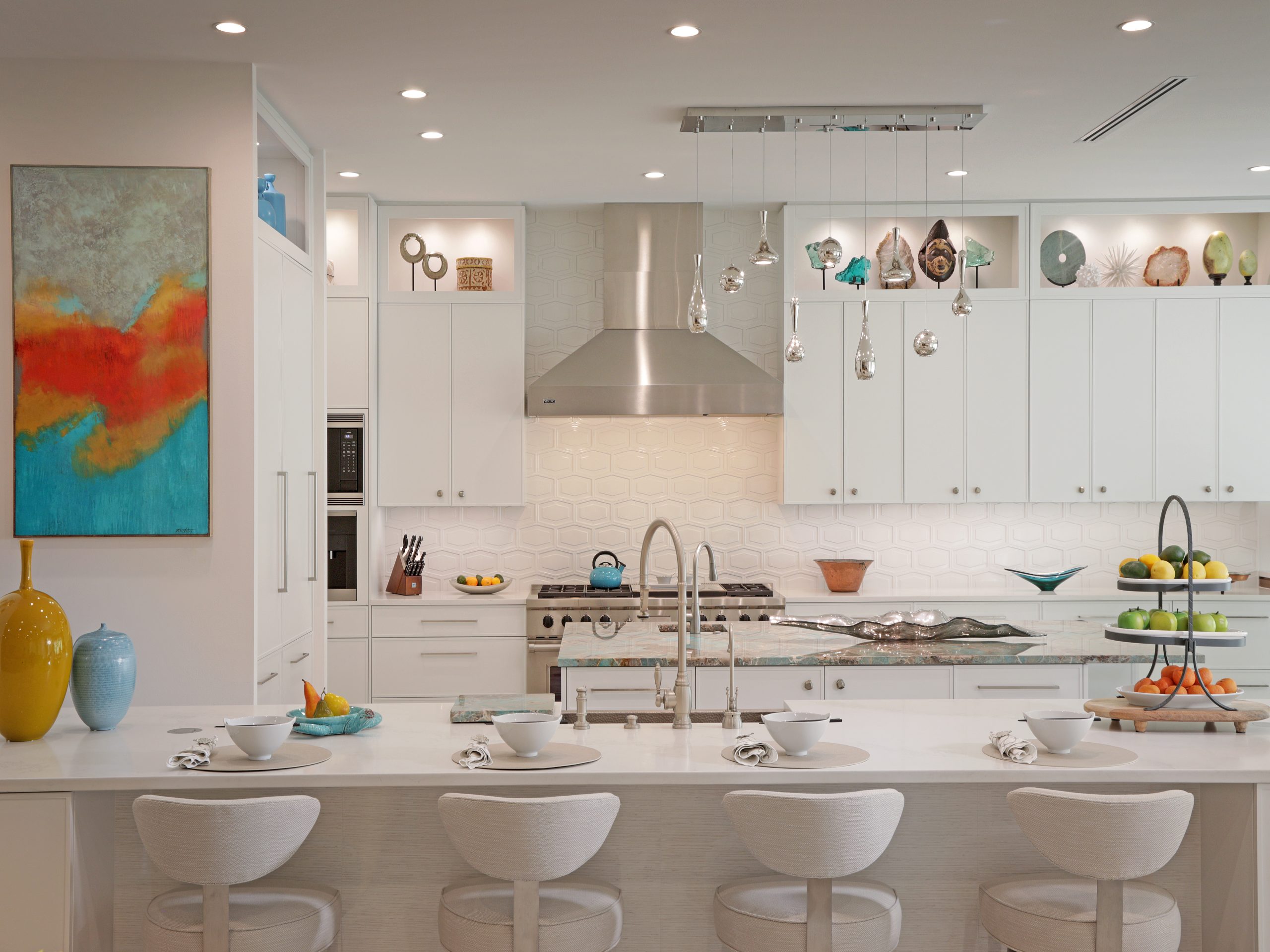 Luxury coastal kitchen cabinets Sarasota, white contemporary cabinetry with open display niches, hexagon tile backsplash, and quartzite island countertop by EuroTech Cabinetry